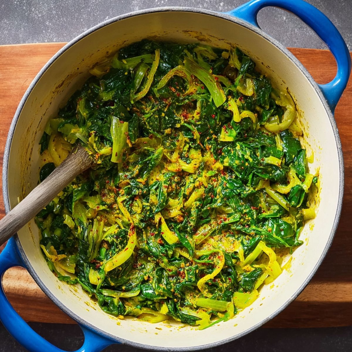 Easy Turmeric Rice with Chickpeas 11 Sautéed leeks and spinach with seasonings in a pot.