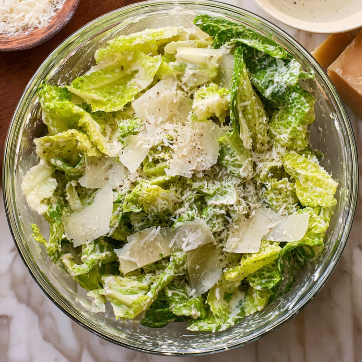 Easy Crispy Chicken Caesar Sandwiches on Brioche Buns 11 The image shows a Caesar salad with romaine lettuce, shaved parmesan, and creamy dressing.