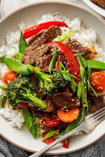 Easy Beef and Vegetable Stir Fry Recipe 1 Beef and Vegetable Stir Fry with broccoli, peppers, and carrots over white rice.
