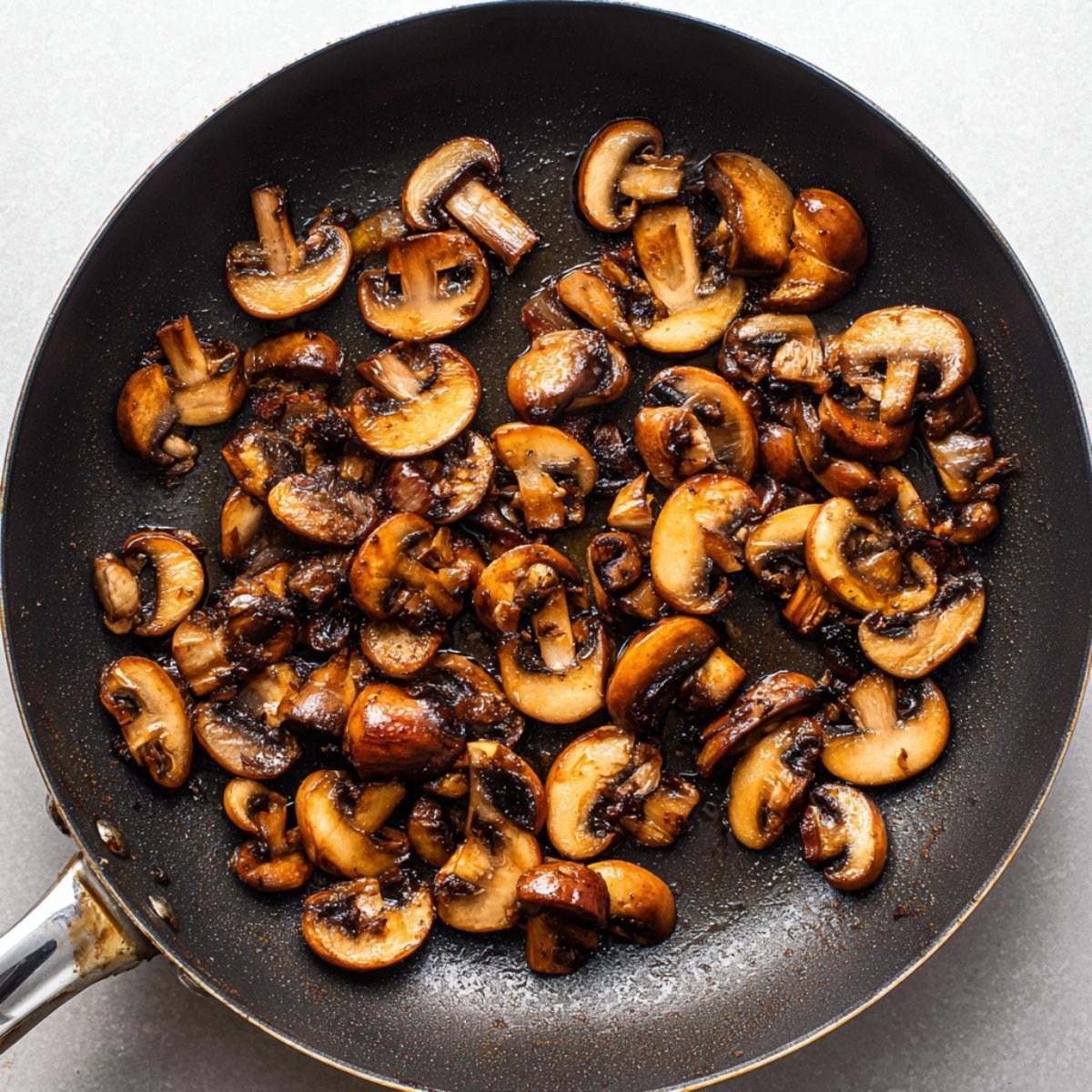 Easy Beef Bourguignon Recipe 11 Sautéed mushrooms in a skillet, browned and caramelized.