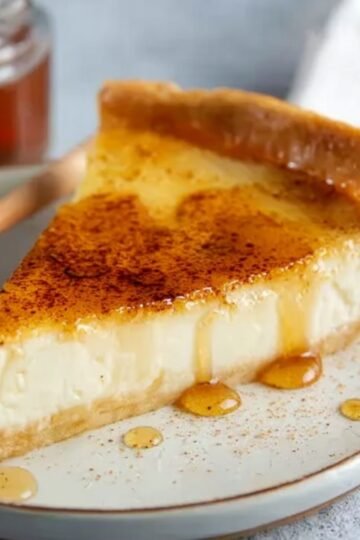 Easy Greek Honey Pie Recipe 14 A slice of Greek Honey Pie with a drizzle of honey on top.