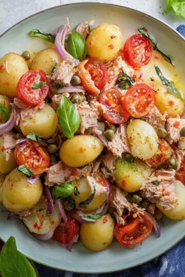 Easy Italian Tuna Salad 9 Italian tuna salad with potatoes, tomatoes, capers, red onions, and fresh basil.