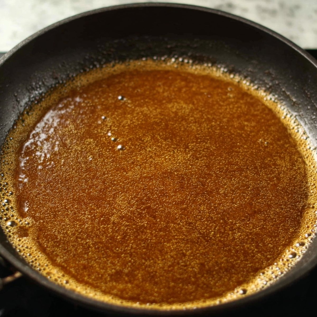Easy Honey Butter Chicken 11 Golden honey butter sauce bubbling in a pan.
