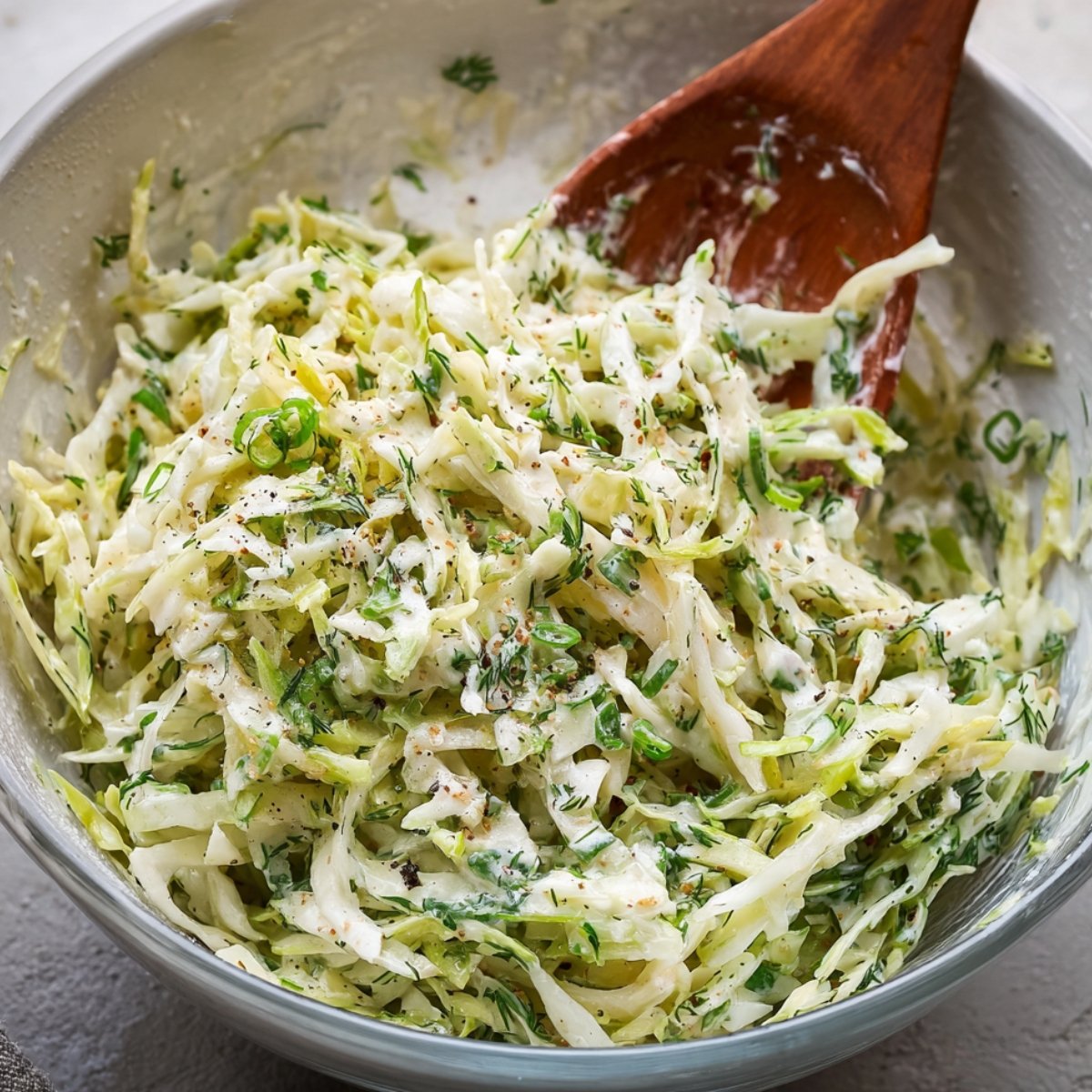 Easy Sheet Pan Chicken Pitas Recipe 11 Freshly made coleslaw with cabbage, herbs, and creamy dressing, mixed in a bowl.