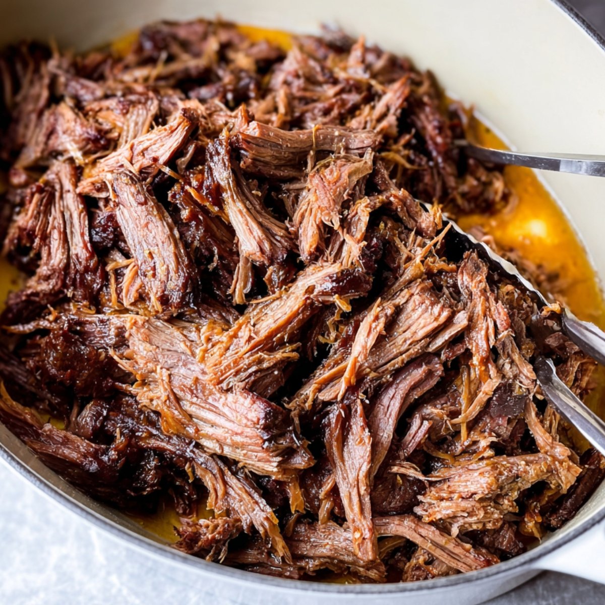 Easy Viral Chuck Roast Recipe 11 Shredded chuck roast in a pot, ready to be served.