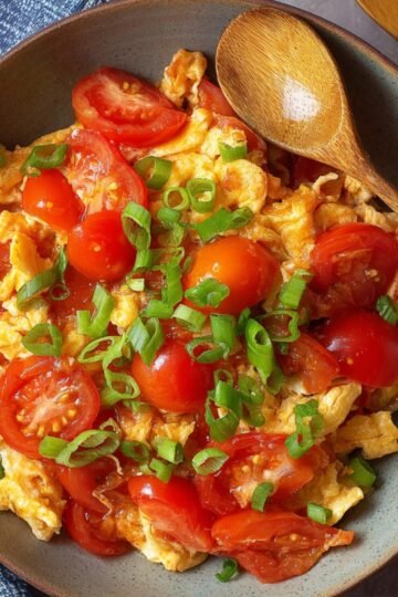 Easy Tomato Egg Stir-Fry 18 Tomato Egg Stir-Fry, garnished with green onions.