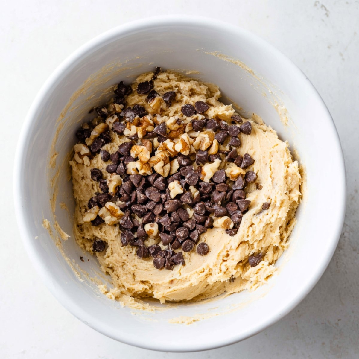 Easy Chocolate Chip Walnut Cookies 11 Cookie dough with chocolate chips and walnuts in a bowl.