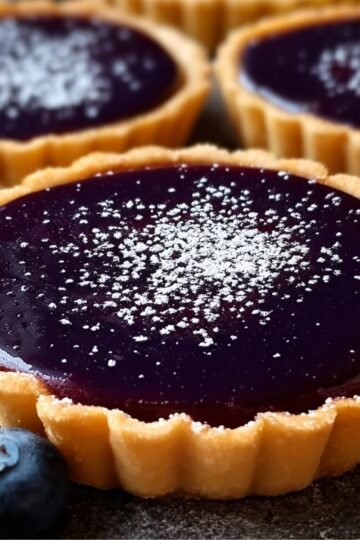 Easy Blueberry Ganache Tart Recipe 12 Blueberry Ganache Tart with powdered sugar and fresh blueberries.