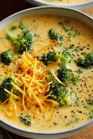 Easy Broccoli Cheddar Soup Recipe 8 Bowl of creamy Broccoli Cheddar Soup with shredded cheese.