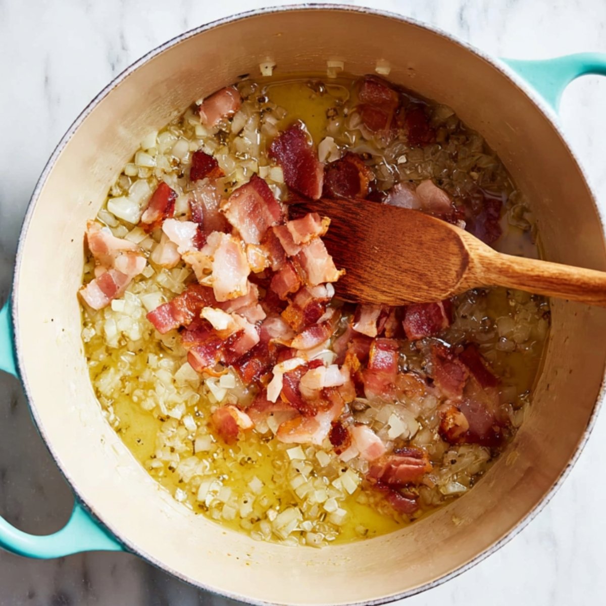 Easy Chicken Potato Soup Recipe 10 Bacon cooking with onions in a pot.