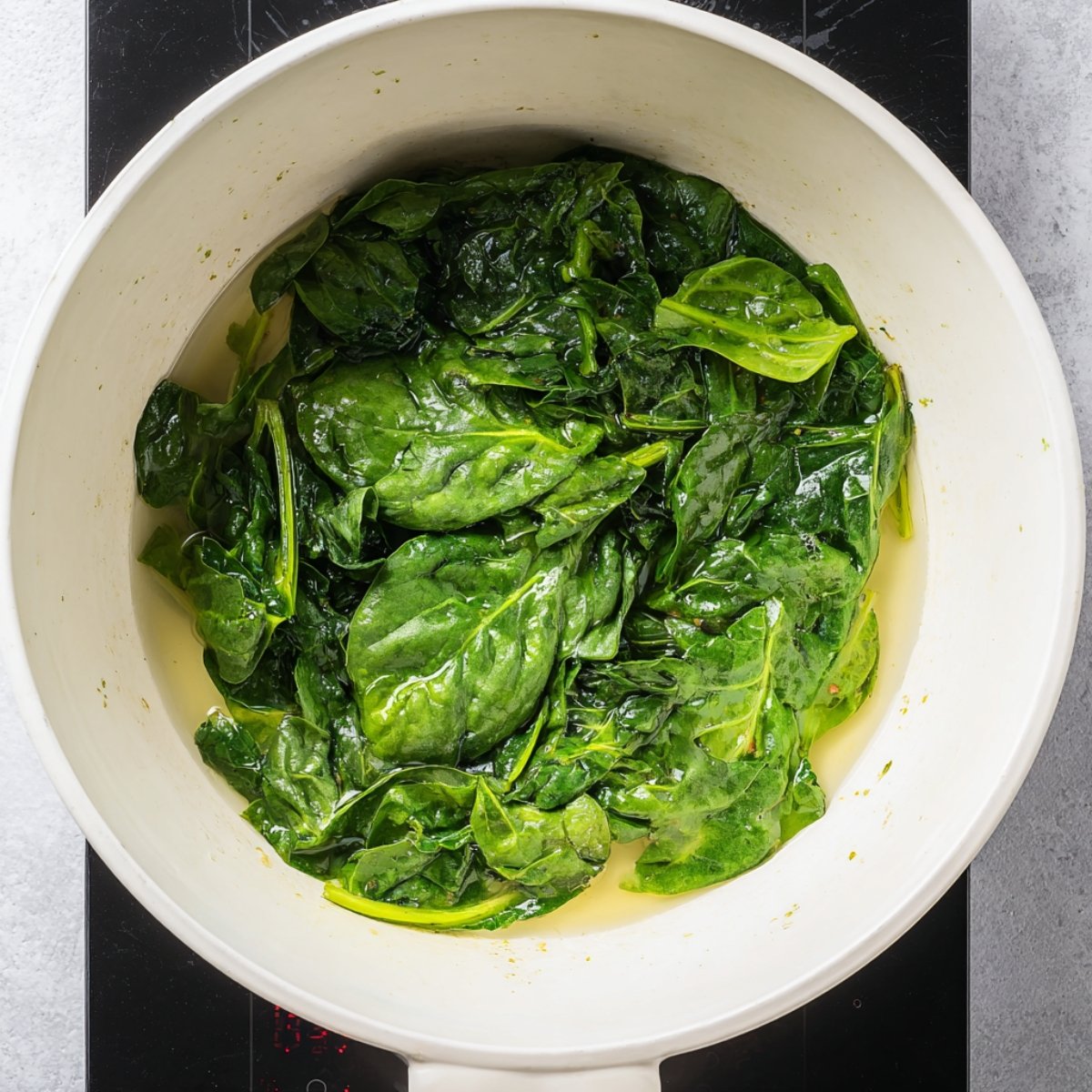 Easy Spinach Mushroom Lasagna 10 Cooked spinach in a pan"