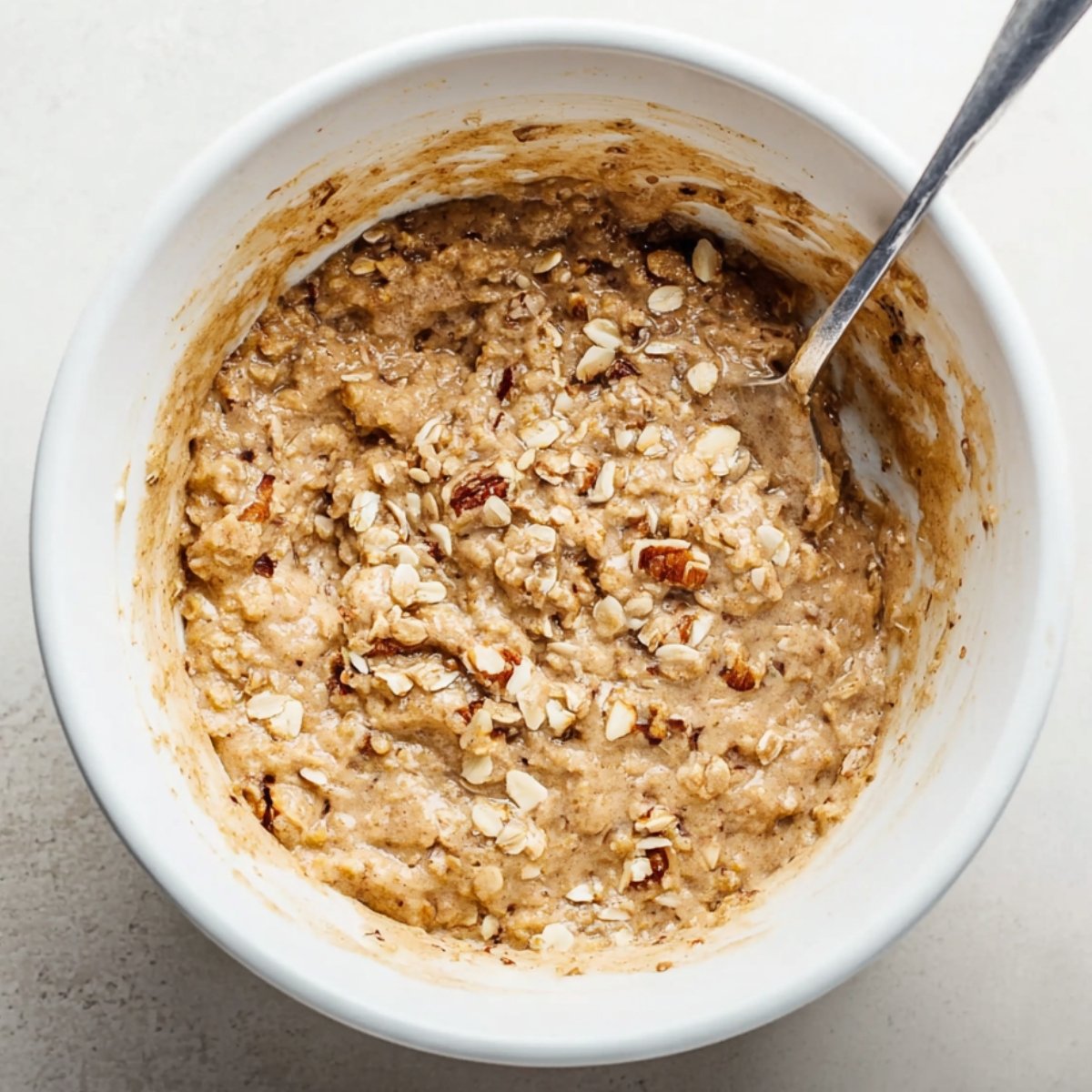 Healthy Banana Muffins Recipe 11 Oat and walnut batter in a bowl.