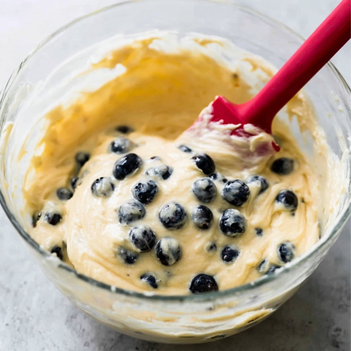 Easy Lemon Blueberry Cupcakes 10 Cupcake batter with fresh blueberries being folded in.