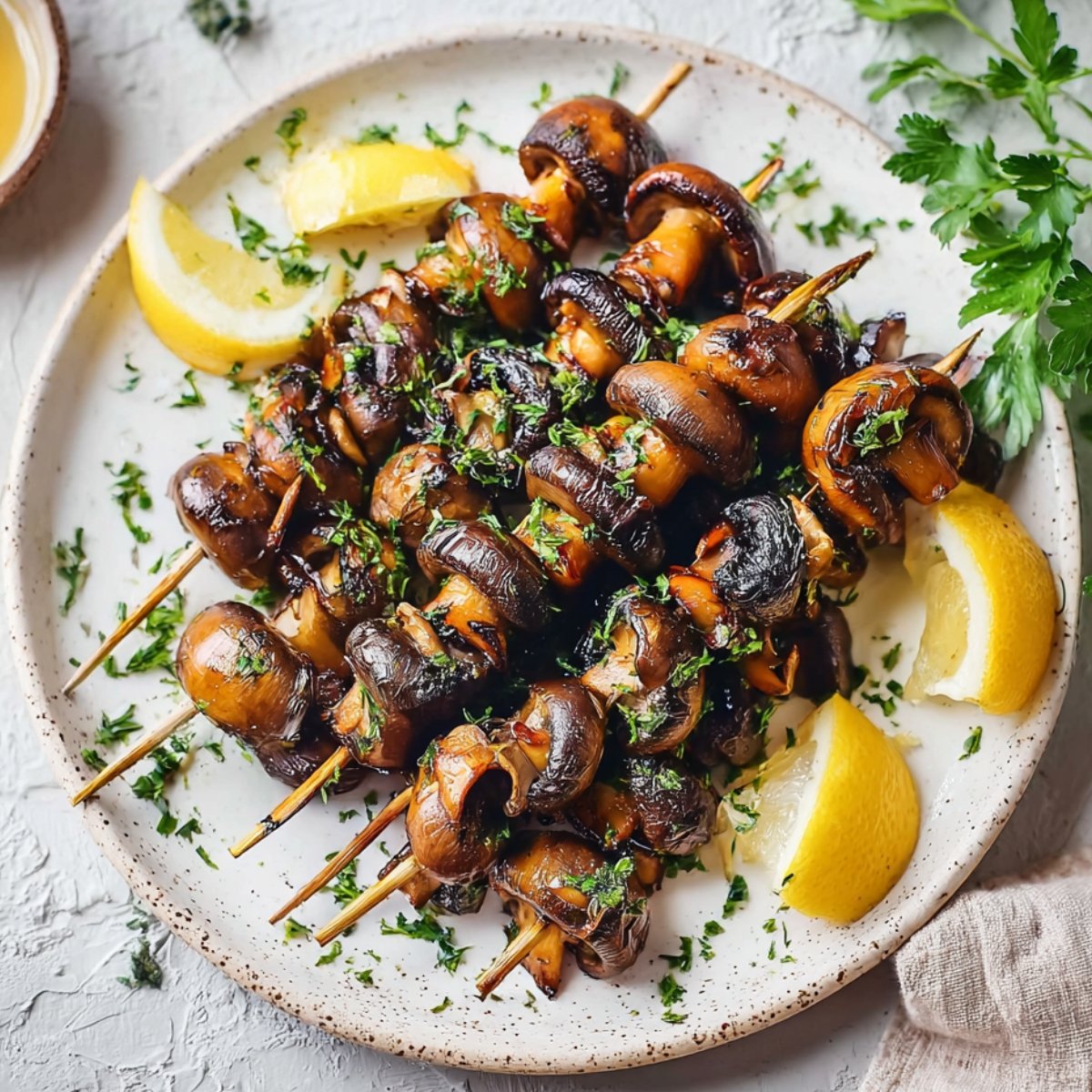 Cooked Grilled Mushroom Skewers garnished with herbs and lemon
