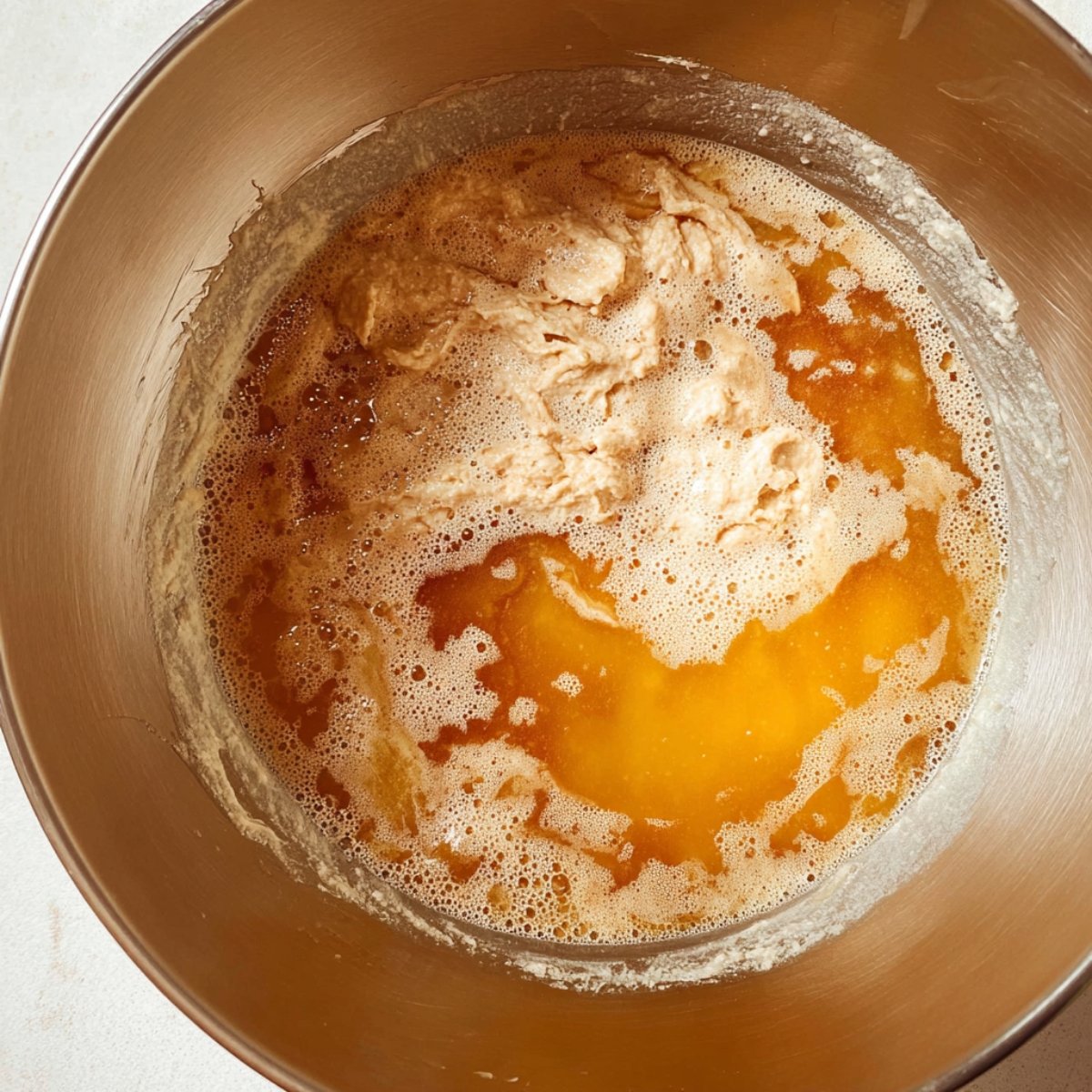 Easy Cinnamon Donut Bread 11 Wet ingredients and yeast in a mixing bowl.