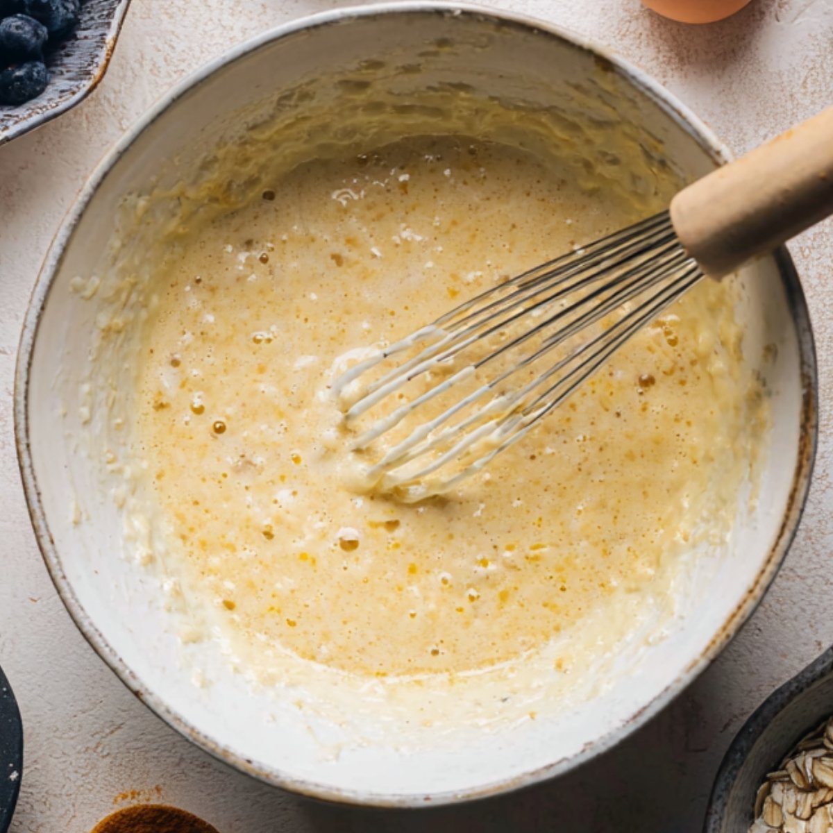Easy Blueberry Baked Oatmeal 10 Wet ingredients being whisked together in a bowl.