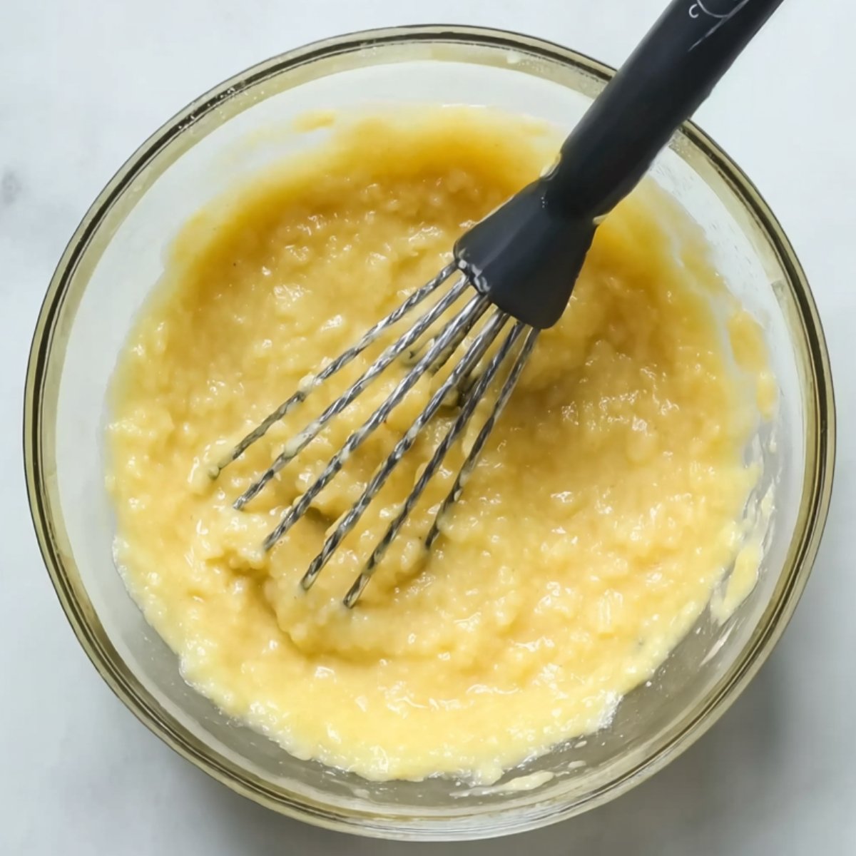 Best Blueberry Banana Bread 10 Whisked wet ingredients in a glass bowl.