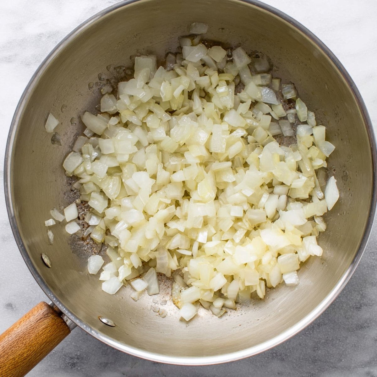 Easy Tomato Rice Recipe 10 Diced onions sautéing in a skillet.