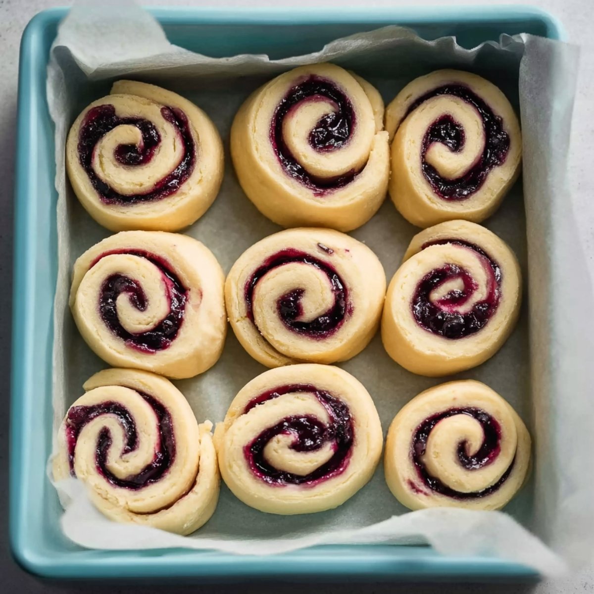 Easy Blueberry Lemon Sweet Rolls 11 Unbaked blueberry sweet rolls in a pan