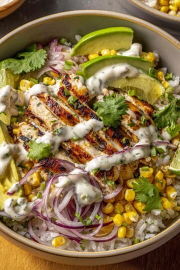 Easy Smoky Street Corn Chicken Bowls 4 Smoky Street Corn Chicken Bowls with rice, avocado, and lime.