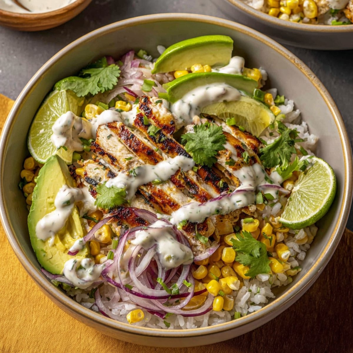 Smoky Street Corn Chicken Bowls with rice, avocado, and lime.
