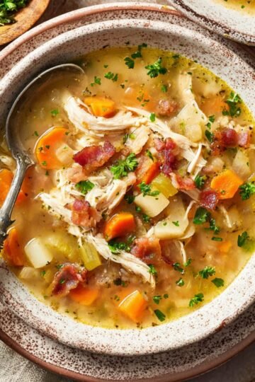 Easy Chicken Potato Soup Recipe 7 Bowl of chicken potato soup with vegetables and bacon.