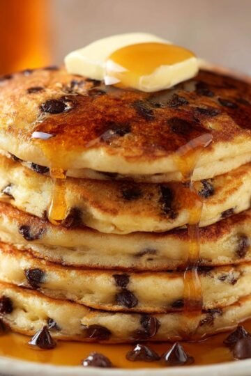 Best Chocolate Chip Pancakes Recipe 18 Stack of chocolate chip pancakes with butter and syrup.